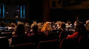 audience in dark movie theater - film festival distribution - gomakemovie