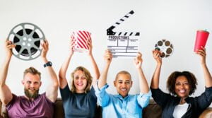 friends holding film reel popcorn and slate - online film distribution - gomakemovie