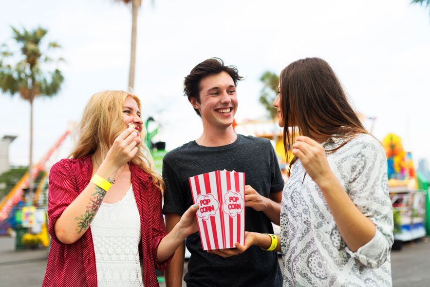 man and two women eating popcorn outside theater - film festival distribution - gomakemovie