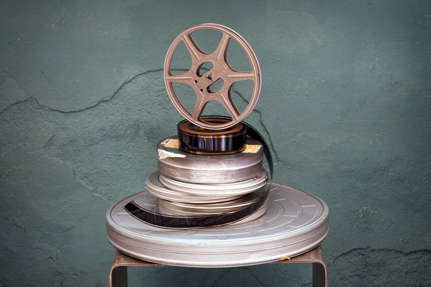 stack of vintage film reels and canisters - diy film distribution - go make movie